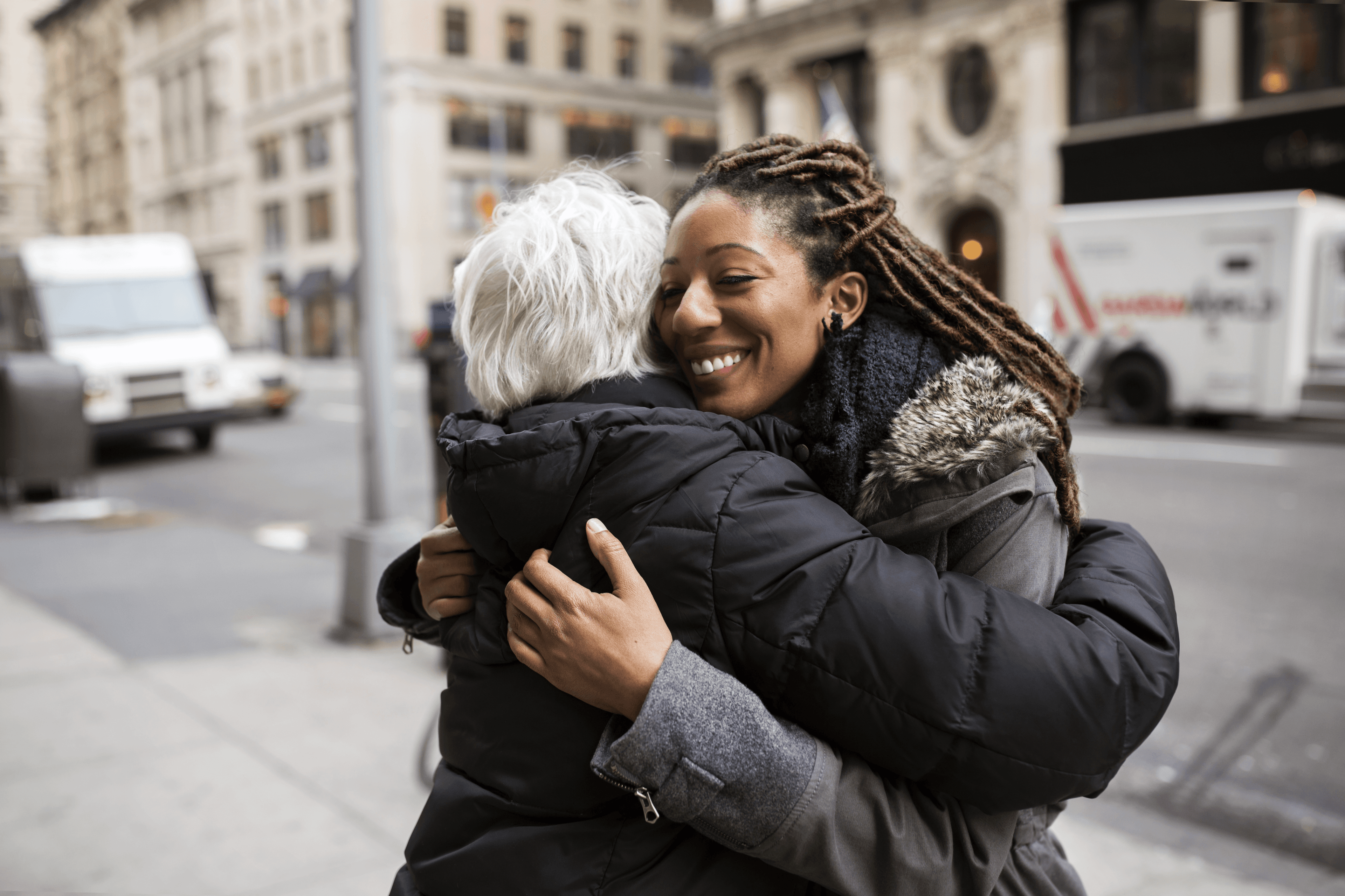 A Helper and senior embracing outdoors